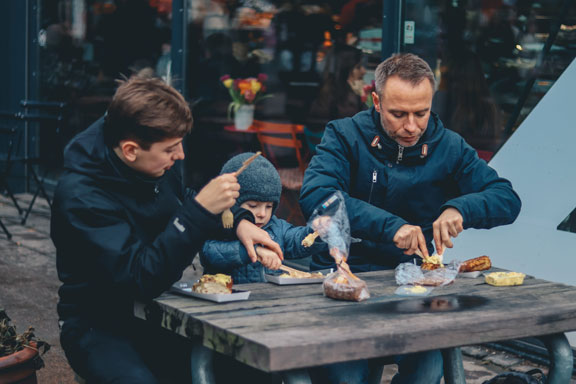 Three generations of men, sharing breakfast